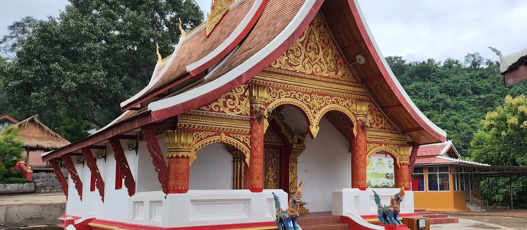The ordination hall at Wat Kiew Nor, with the hill behind it.